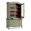 Wood and glass display cabinet in sage green finish with four shelves and three drawers